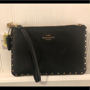 Coach black leather wristlet with gold accent